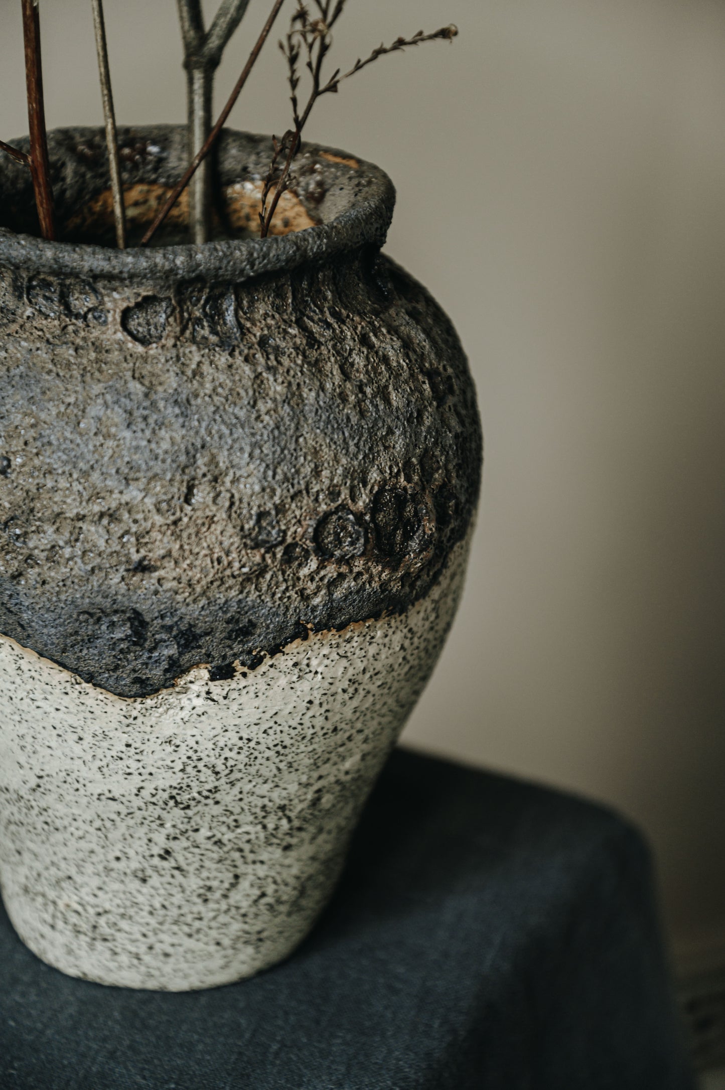 Ceramics vase with black magma glaze and white background