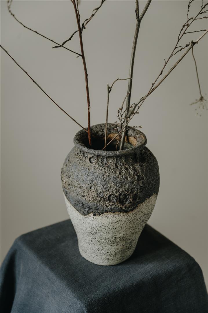 Ceramics vase with black magma glaze and white background