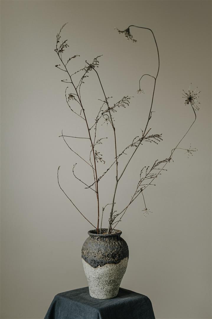 Ceramics vase with black magma glaze and white background