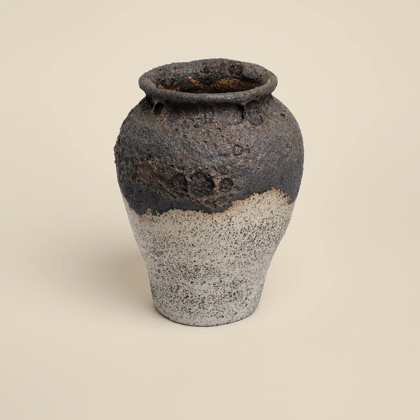 Ceramics vase with black magma glaze and white background
