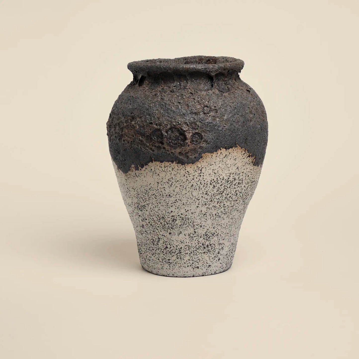 Ceramics vase with black magma glaze and white background
