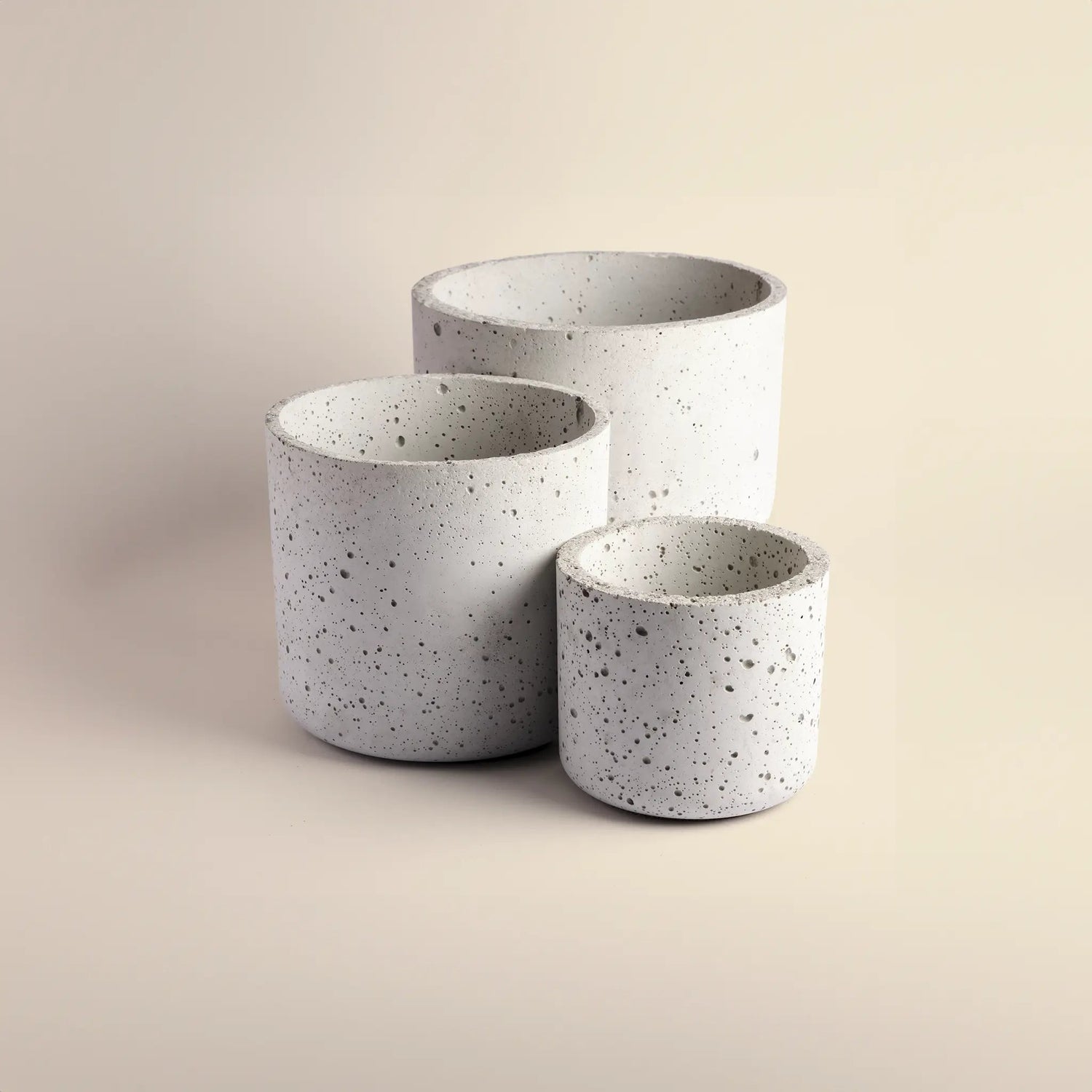 Set of three flower pots handmade from concrete, small, medium and large. 