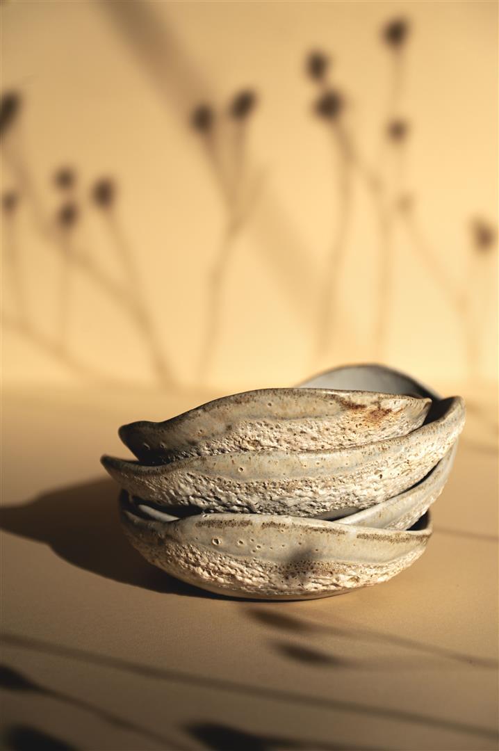 Small ceramics bowl handmade from grey clay. The image is of four bowls stacked on top of one another.