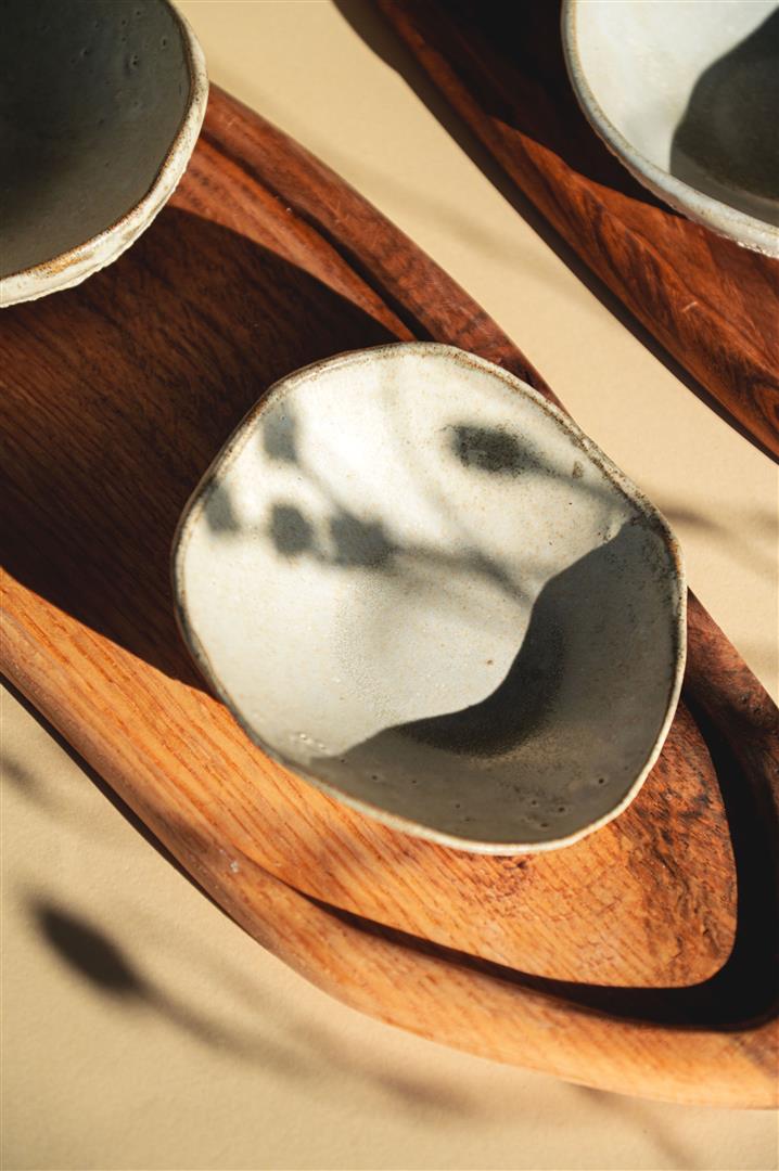 Lava Pulse Ceramics Set is a handmade set of two small ceramics bowls on a wooden board.