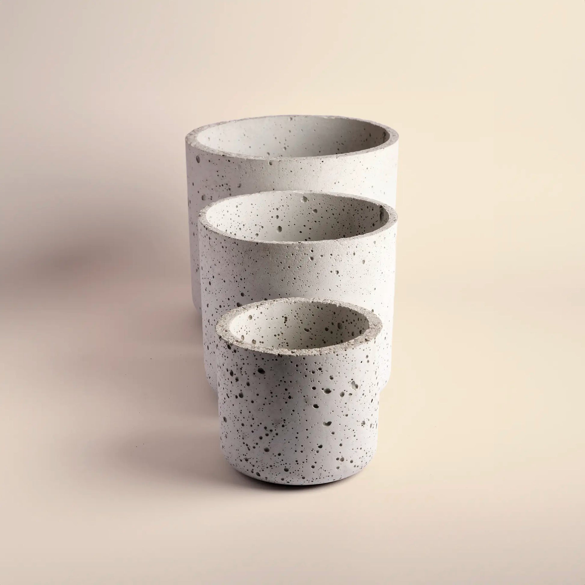 Set of three plant pots handmade from concrete, large, medium and small.