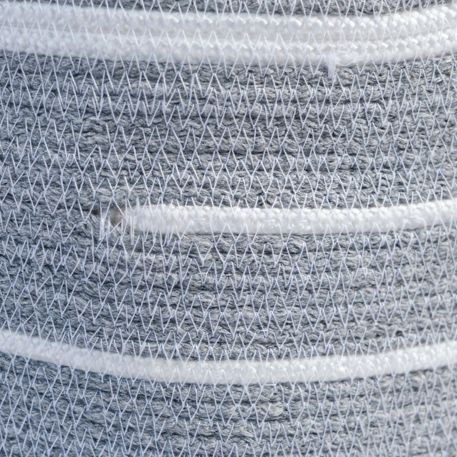 Detail of the stitching of the Halo chandelier made from cotton rope. It is white with grey details.