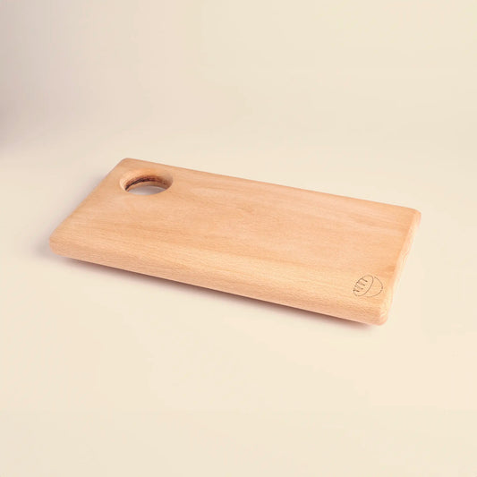 Cutting board handmade from beech wood with carved image of a bread. 