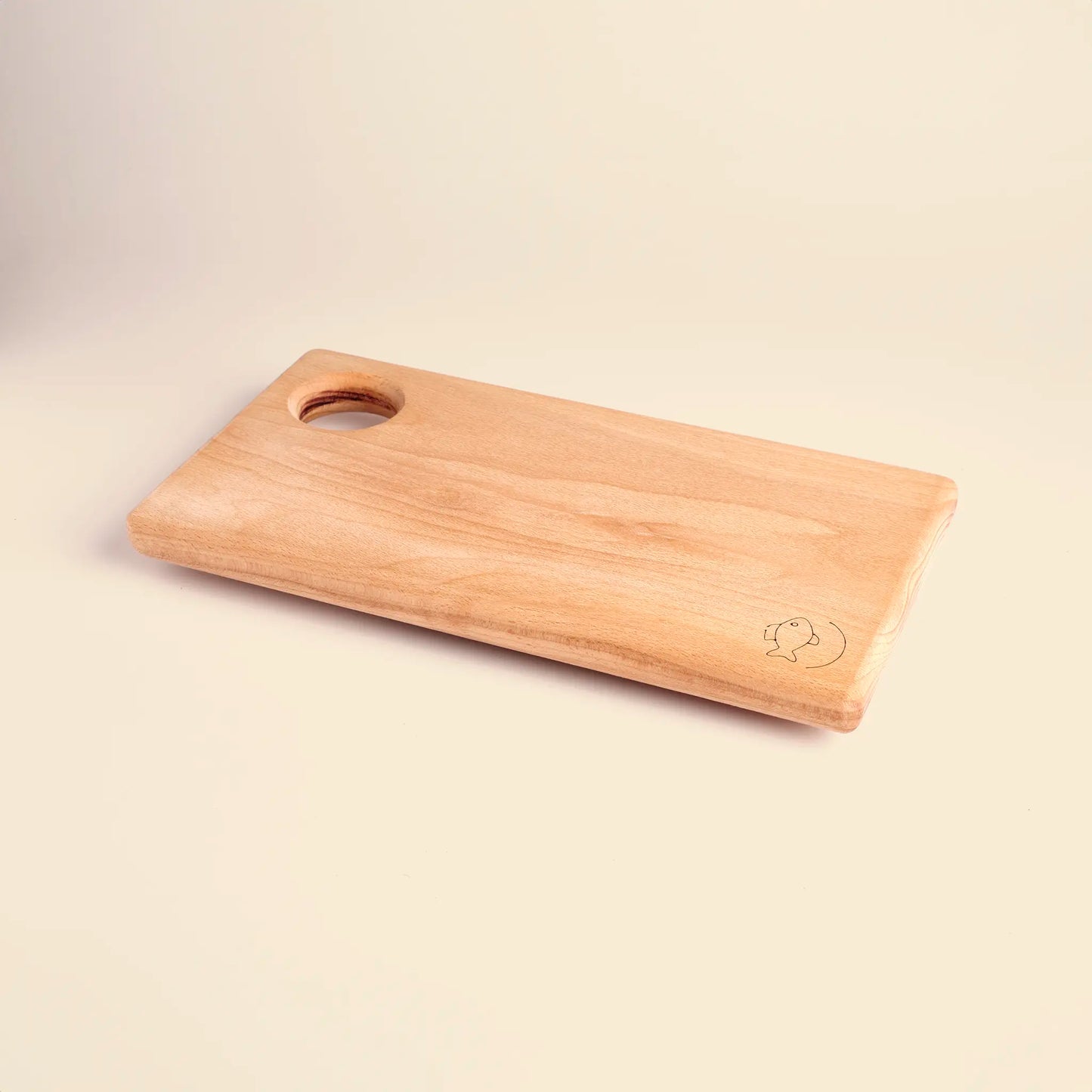 Cutting board handmade from beech wood with carved image of a fish. 