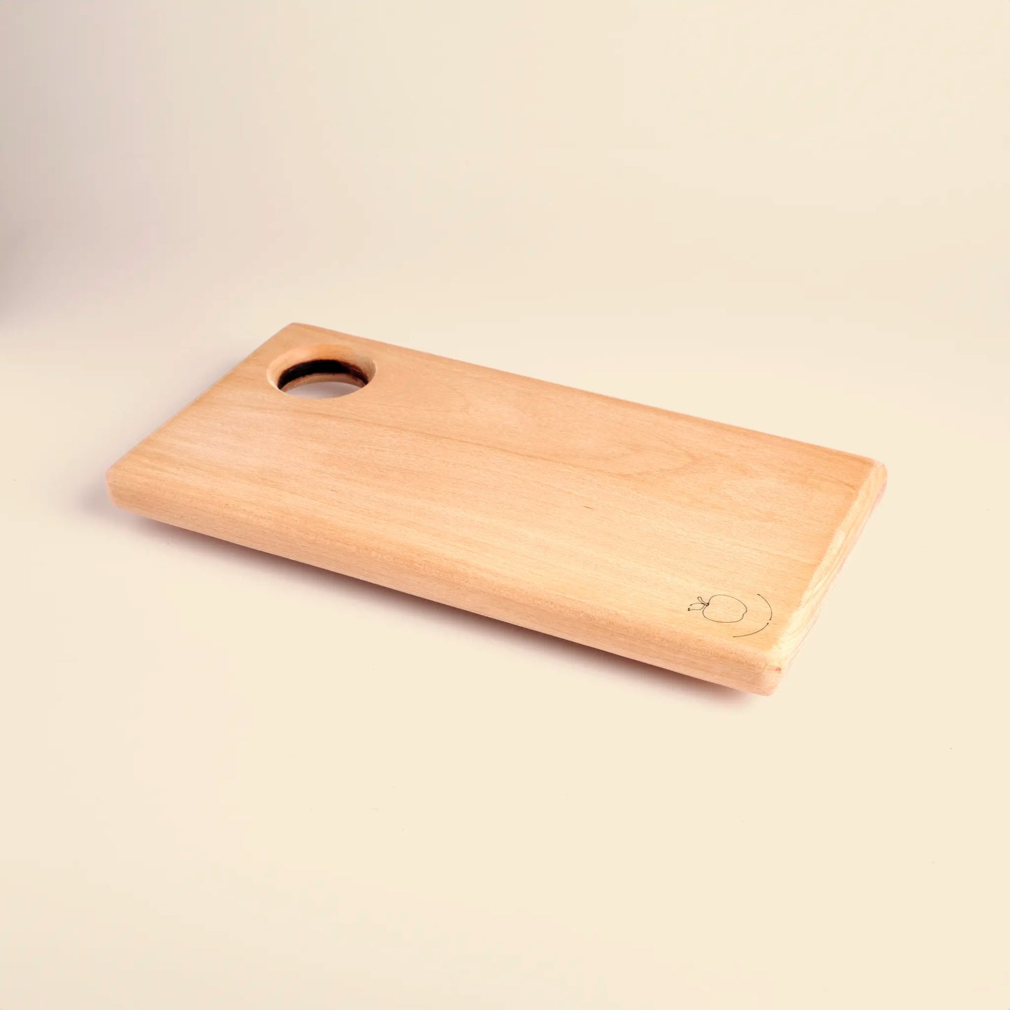 Cutting board handmade from beech wood with carved image of an apple