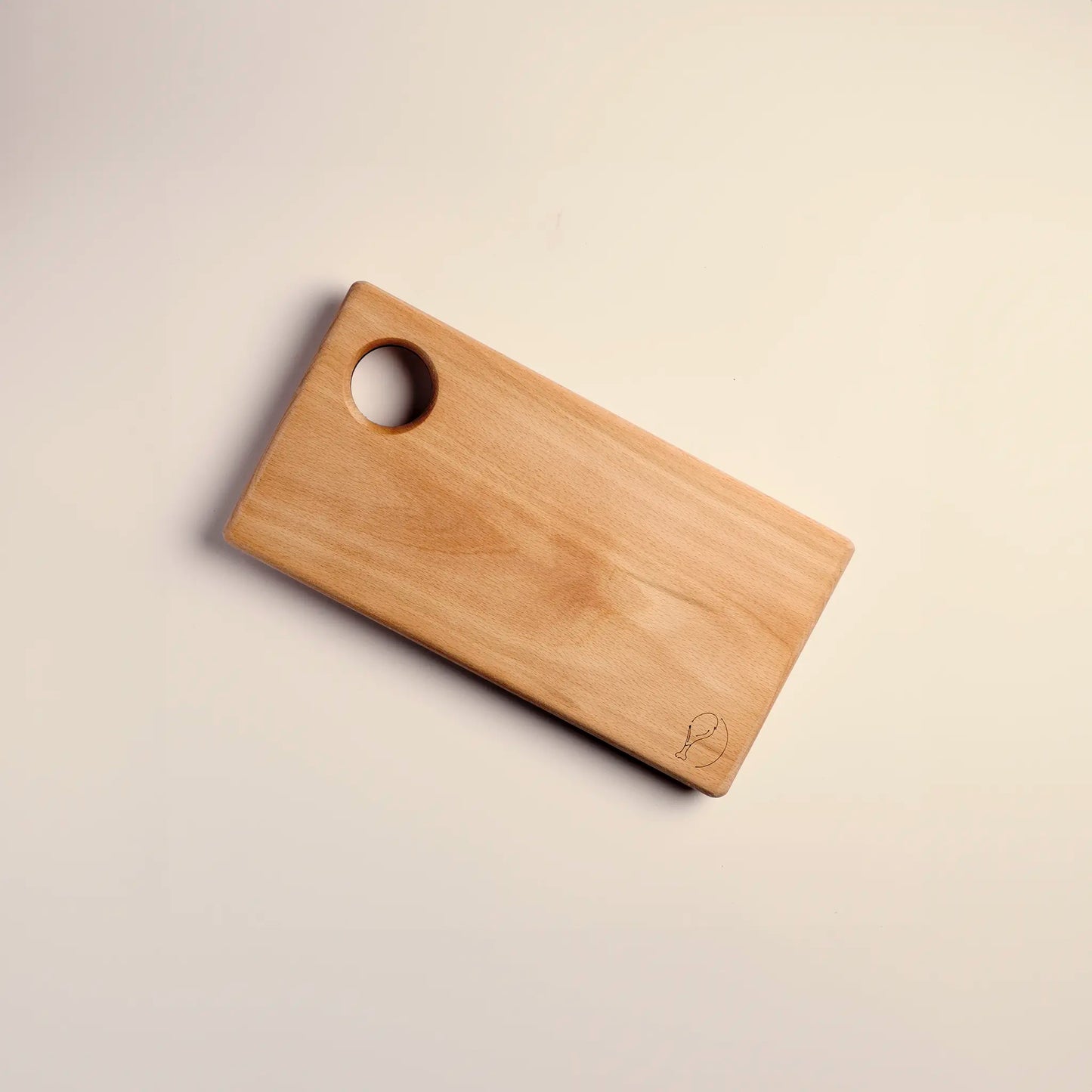 Cutting board handmade from beech wood with carved image of a piece of meat