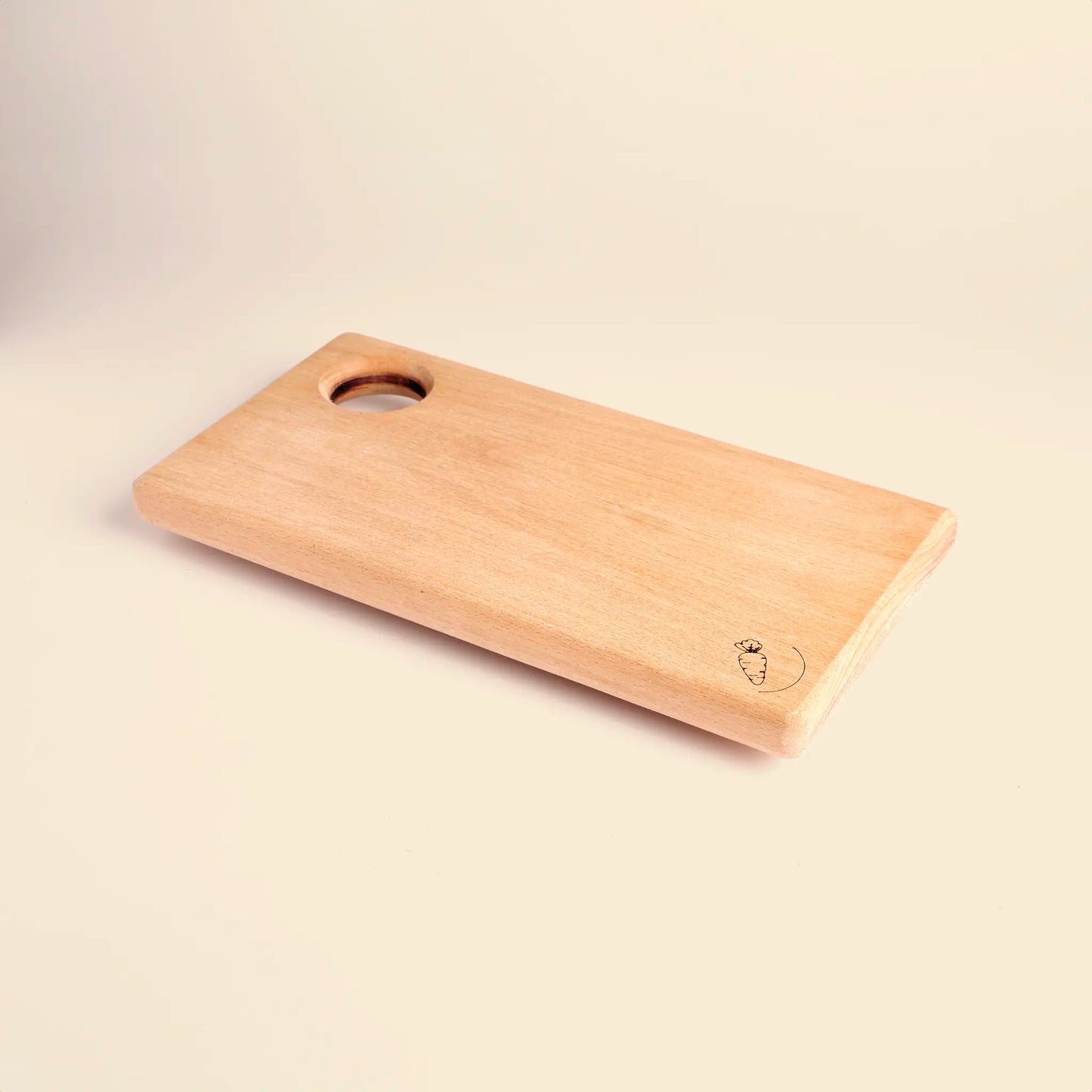 Cutting board handmade from beech wood with carved image of a carrot. 