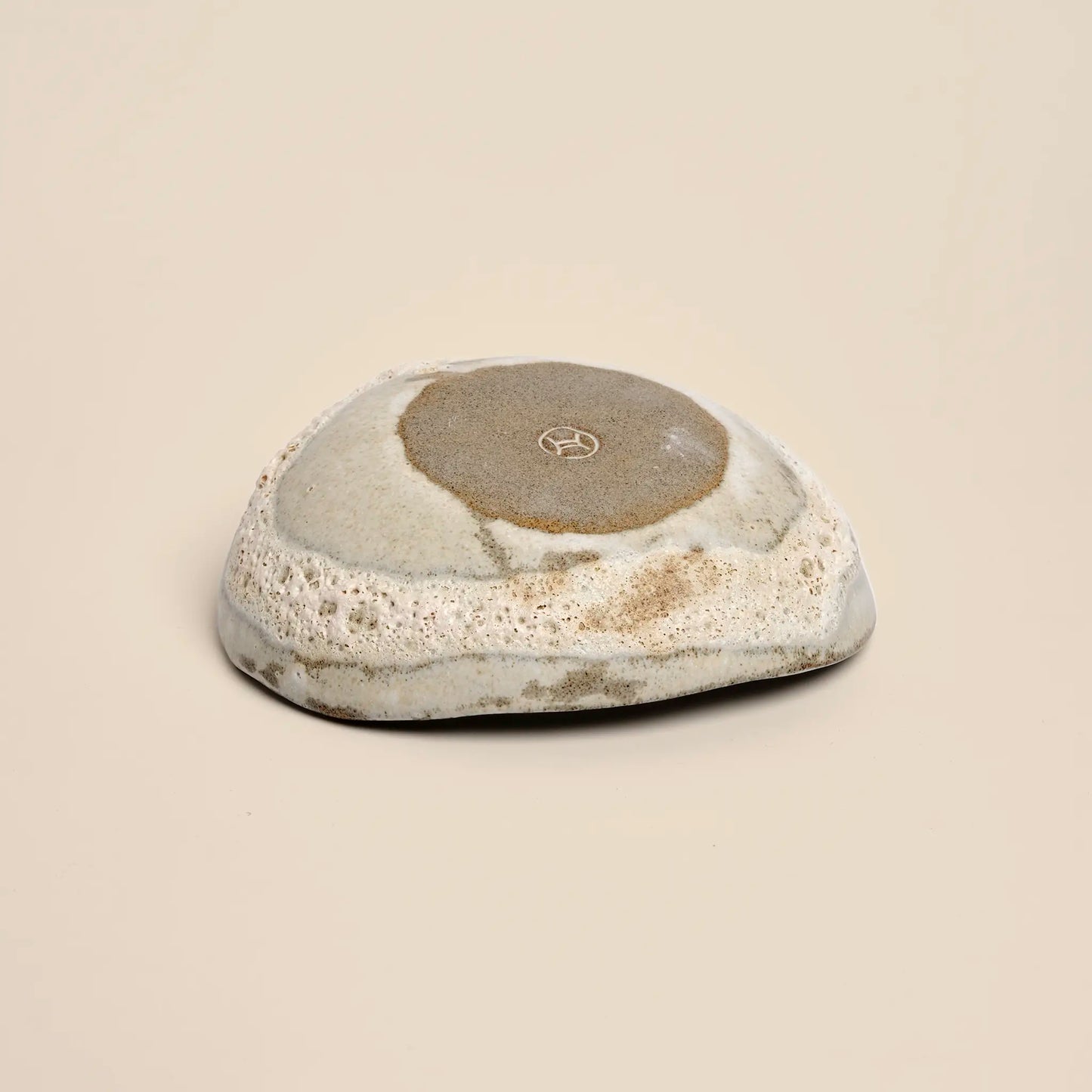 Small ceramics bowl handmade from grey clay, bottom view