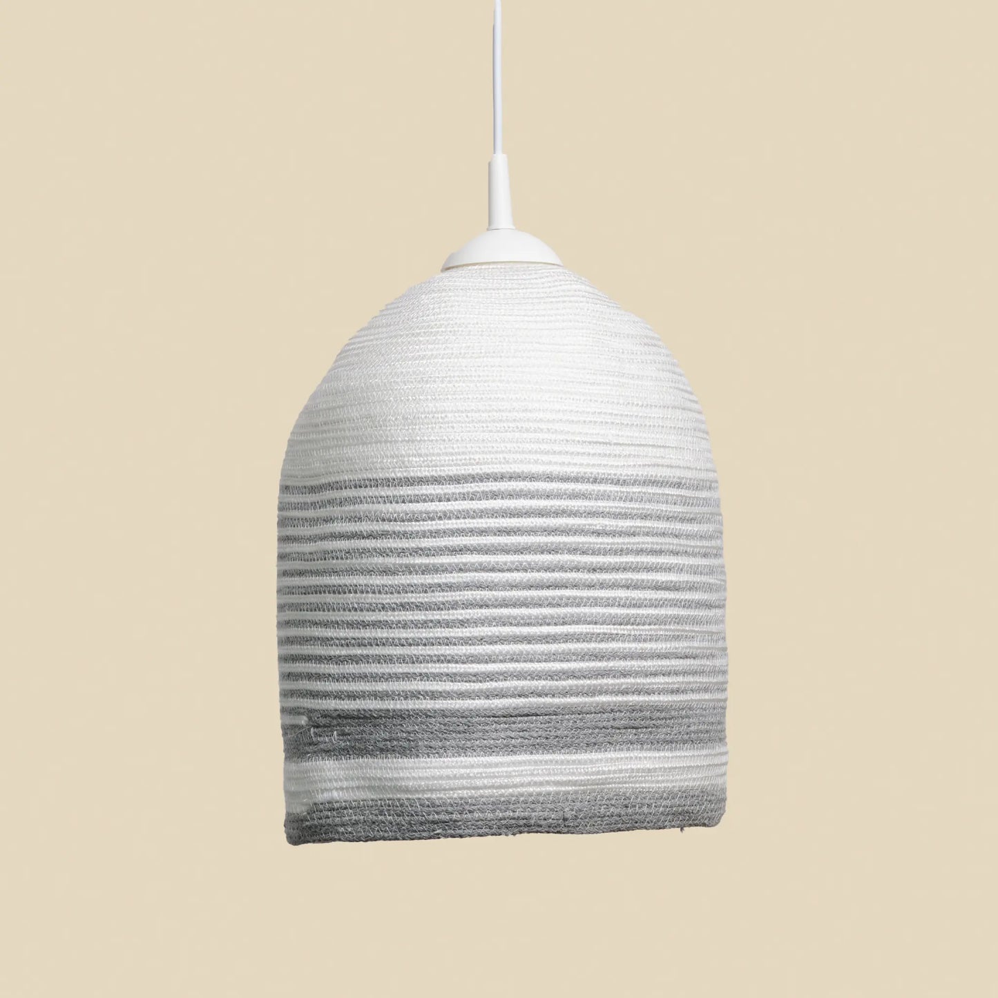 Large circular Loom chandelier made from cotton rope. It is white with grey details. 