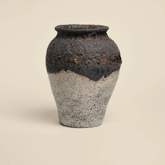 Ceramics vase with black magma glaze and white background