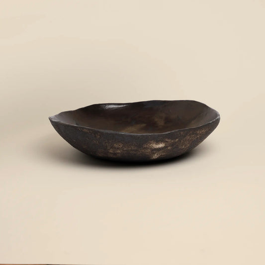 Magma flow ceramics bowl is made from black ceramics and has a unique shape.