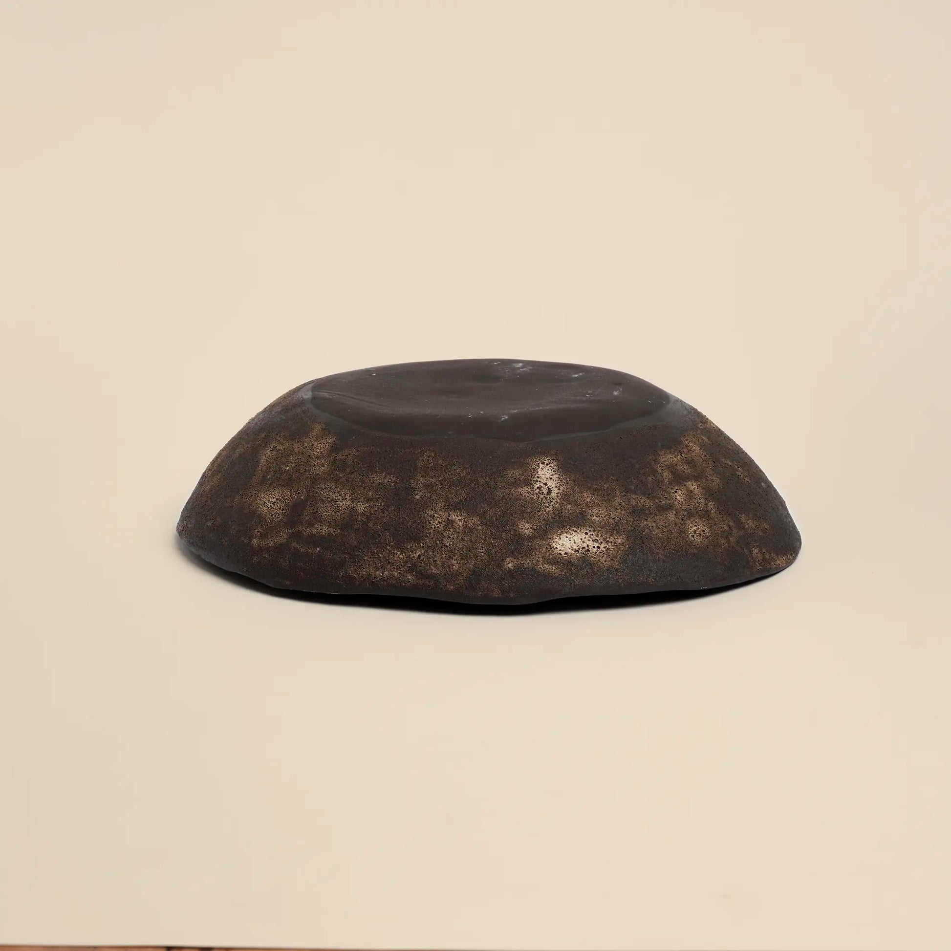 Magma flow ceramics bowl is made from black ceramics and has a unique shape.