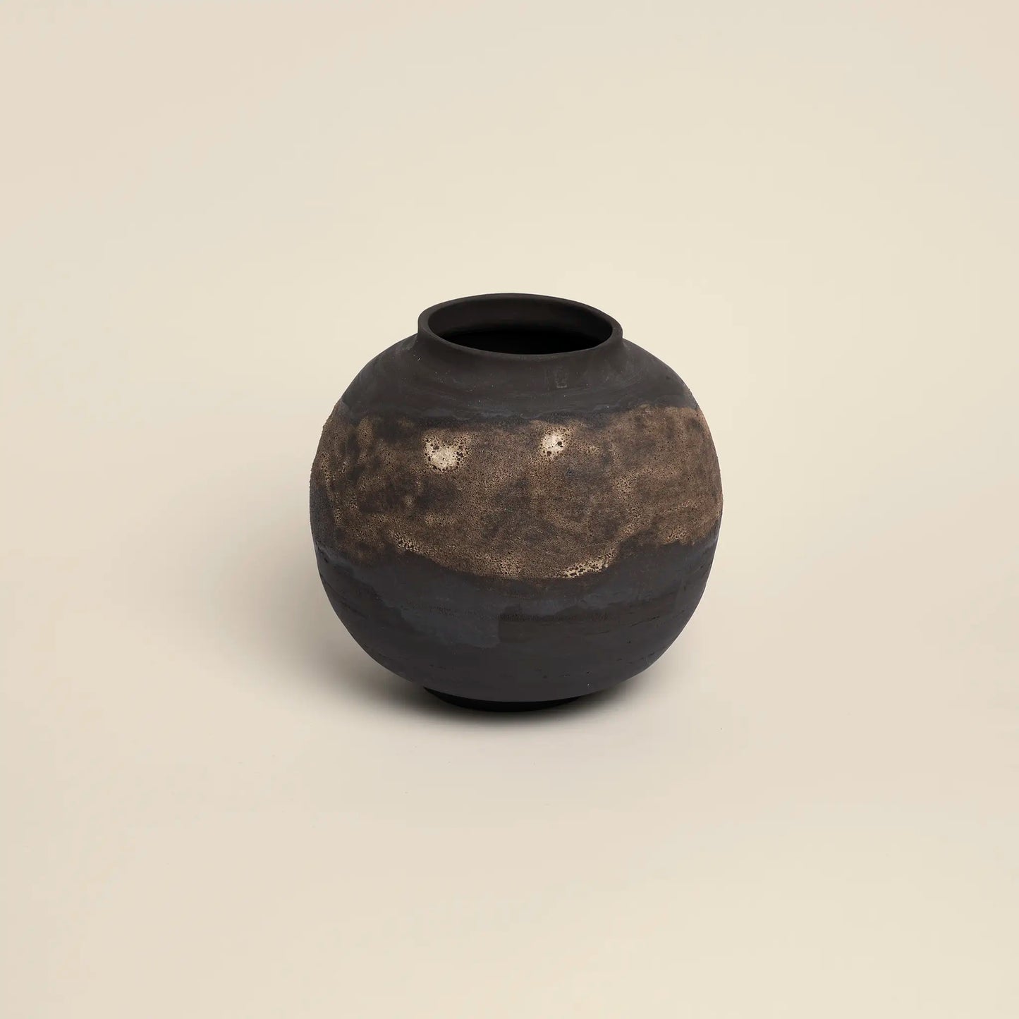 Ceramics vase with golden glaze and dark brown background